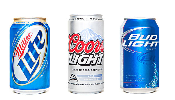 Beer Cans Nashville, Tennessee, USA - June, 26th 2011: Miller Lite, Coors Light, and Bud Light beer cans, the three most popular American light beer brands, lined up in a row isolated against a white background. Can of Coors Light stock pictures, royalty-free photos & images