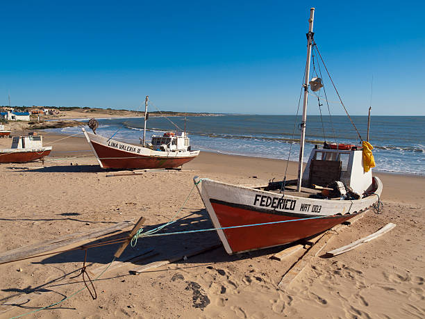 Devil's Point in Uruguay Punta del Diablo, Uruguay - November 8, 2009: Small fishing boats on the beach at Punto del Diablo in Uruguay uruguay photos stock pictures, royalty-free photos & images
