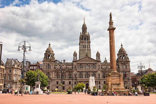 George Square, Glasgow Glasgow, UK - July 1, 2011: Office workers, tourists and locals enjoy a quiet summer afternoon in George Square in Glasgow City Centre. The Victorian City Chambers building forms the backdrop. editorial architecture famous place local landmark stock pictures, royalty-free photos & images