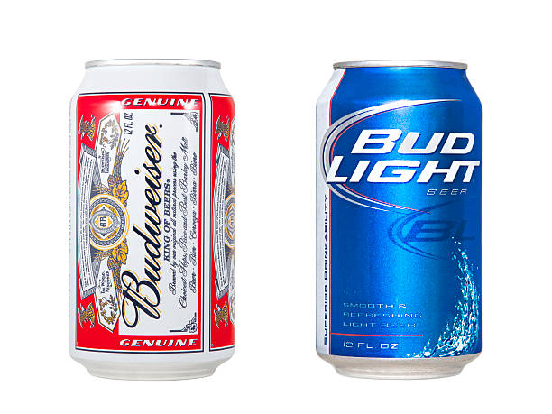 Budweiser and Bud Light Nashville, Tennessee, USA - June 4th, 2011: A Budweiser beer can with red and white label beside a Bud Light beer can with the signature blue and white label, isolated on white. Can of Budweiser stock pictures, royalty-free photos & images