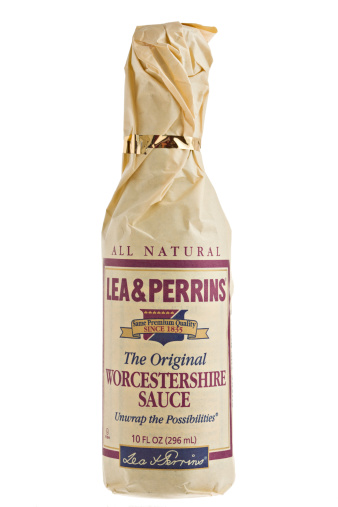 Chico, California, USA - May 14,2011 : A close up of a 10 FL OZ bottle of Lea & Perrins original Worcestershire Sauce in its famous brown paper wrap. Lea & Perrins began wrapping the bottles in paper to prevent breakage during long and lengthy sea voyages as they exported their product all over the world.