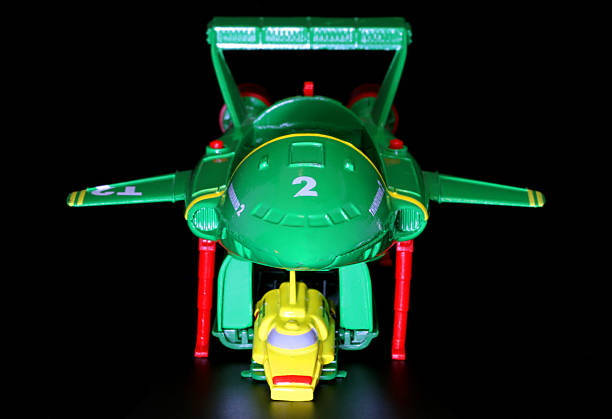 Vancouver, Canada - January 29, 2012: Thunderbird 2 and 4, from the Thunderbirds television series, against a black background. The toys are from Matchbox.