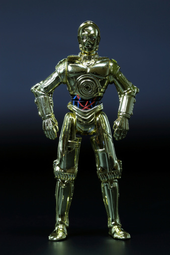 Vancouver, Canada - May 8, 2011: A C3PO figurine from the Hasbro line of Star Wars toys, posed against a black background.
