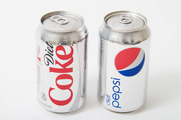 Liberty Township, Ohio, USA - February 24, 2011: An isolated can of Diet Pepsi soda and Diet Coke soda which is distributed by PepsiCo and The Coca Cola Company respectively. Diet Coke and Diet Pepsi are direct business competitors. 