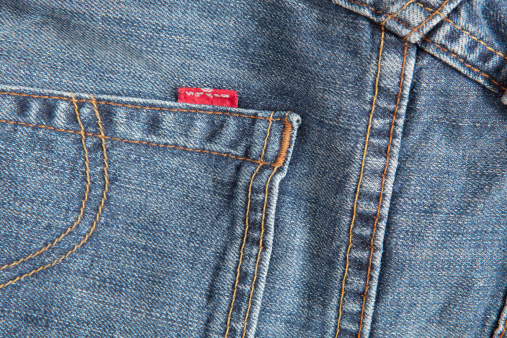 Soest, Netherlands, - August 6, 2011: Close-up of red label logo and stitching on Back Pocket of a Pair Levi\'s Jeans.Picture is made in my Daylight Studio.Photographed with Canon 5dmkII with Canon 24-70mm and 100mm Macro Lenses in RAW 16bit and Adobe RGB and professionally processed.