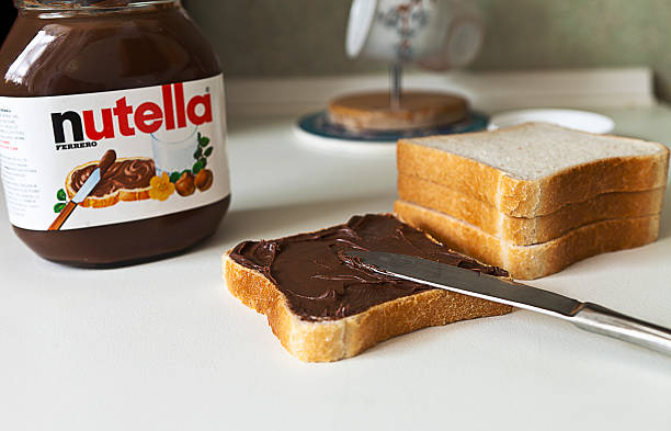 Nutella Istanbul, Turkey - February 10, 2012 : Nutella chocolate cream and bread are ready for breakfast on February 10, Istanbul, Turkey. nutella stock pictures, royalty-free photos & images