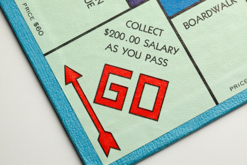 San Diego, California, USA - May 12, 2011: The starting point on the Parker Brothers board game of Monopoly. Parker Brothers, a subsidiary of Hasbro, has produced the game since 1935. It is the most successful board game in history. Shot in a studio setting on a white background.