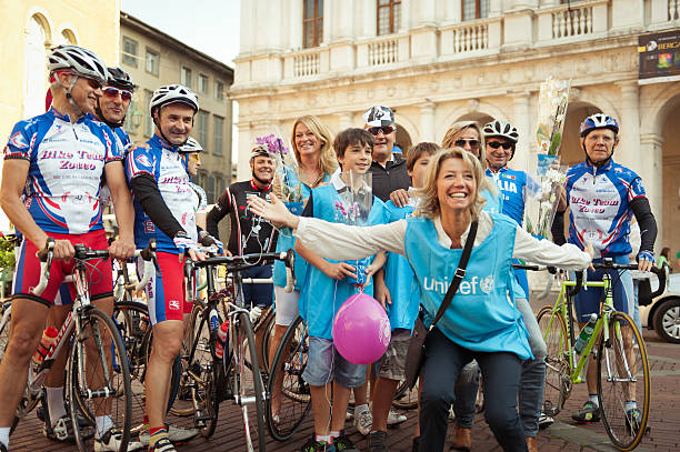 Amateur ciclists and Unicef volunteers in Bergamo, Italy Bergamo, Italy - October 2, 2011:  Group of amateur cyclists and Unicef volunteers in Bergamo, Italy unicef stock pictures, royalty-free photos & images