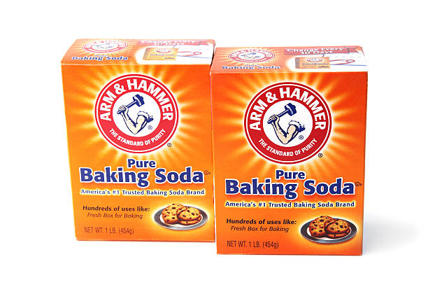 Arm and Hammer Baking Soda West Palm Beach, USA - April 27, 2012: This is a studio shot of two boxes of Arm and Hammer Baking Soda. Baking Soda is used as a baking ingredient, but also has many other uses around the kitchen, such as cleaning and odor control. Arm and Hammer uses their baking soda in many products, from laundry detergent to tooth paste. arm hammer stock pictures, royalty-free photos & images