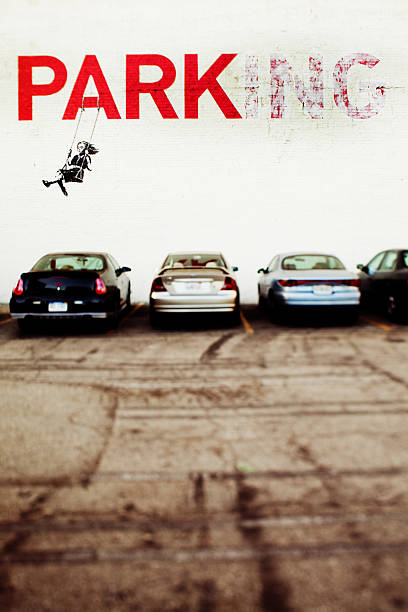 Banksy in Los Angeles Los Angeles, California, USA - July 1, 2010:  &quot;Parking&quot; by British street artist Banksy appears in a parking lot near 9th &amp; Broadway in downtown Los Angeles. banksy stock pictures, royalty-free photos & images