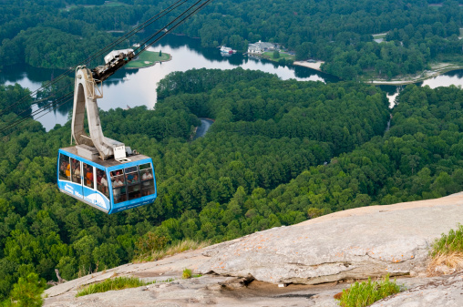 Stone Mountain Park, GA, USA - August 1, 2011: A cable car carries visitors to the top of Stone Mountain, one of the biggest tourist attractions in Georgia. The park covers 3,200 acres and the granite mountain rises to  1686 feet above sea level.