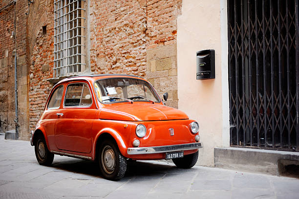 Lucca, Italy - June 27, 2011: Vintage Fiat 500 parked in a street in the medieval town of Lucca, Italy. A compact and affordable two door town car, the Nuova 500 was manufactured by Fiat between 1957 and 1975.