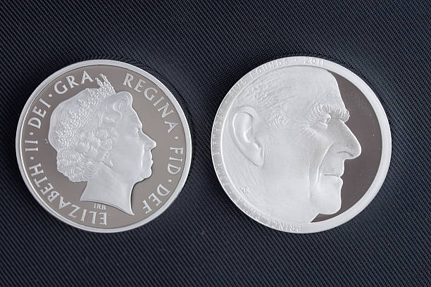 Five Pound Silver Piedfort Coin "Narberth, Wales - June 22, 2011: Reverse and obverse sides of a British silver piedfort coin with a face value of five pounds, struck in 2011 by the Royal Mint to commemorate the 90th birthday of His Royal Highness Prince Philip, Duke of Edinburgh, on June 10th 2011." prince phillip stock pictures, royalty-free photos & images