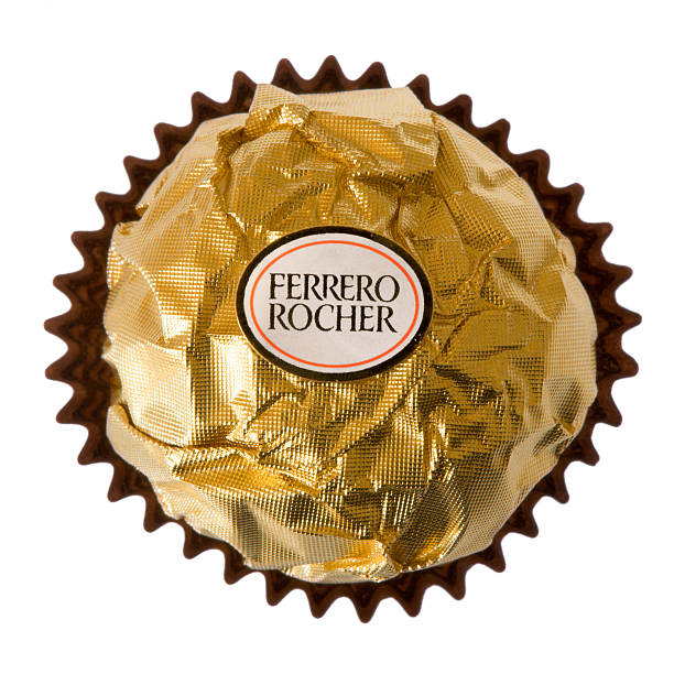 Ferrero Rocher Praline isolated on white Background Essen, Germany - March 21, 2011: A chocolate Ferrero Rocher manufactured by Ferrero. Ferrero is an international Italian confectionery manufacturer. aromatisch stock pictures, royalty-free photos & images