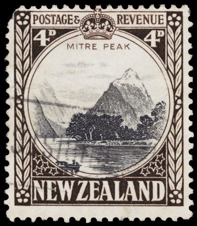 Sacramento, California, USA - April 6, 2012: A 1936 New Zealand postage stamp with an illustration of Mitre Peak, a landmark in  Milford Sound in Fiordland National Park on the South Island of New Zealand.