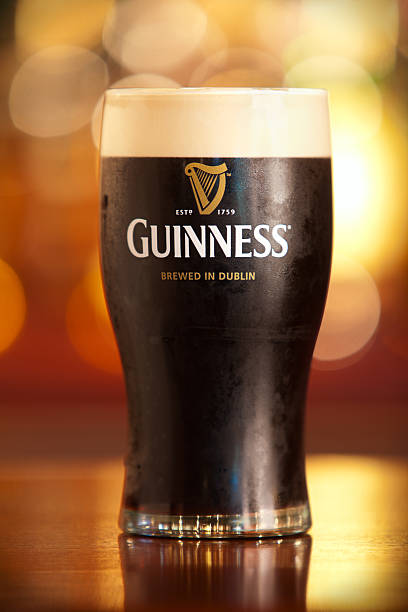 Pint of Guinness. "Minnetonka, MN, USA - August 8, 2011: Studio shot of a pint of Guinness in a bar setting with nice bokeh in the background." guinness photos stock pictures, royalty-free photos & images