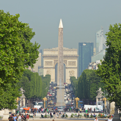 Paris, France - May 5, 2011: Daytime telephoto view of the congested Avenue des Champs-Elysees leading from the Obelisk of Luxor at the Place de la Concorde to the Arc de Triomphe.