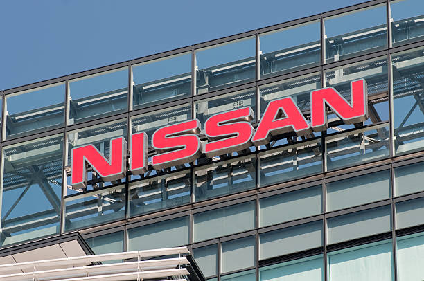Sign of Nissan "Yokohama, Japan - Aprir 1, 2011: The sign of Nissan Motor Company on the top of the office building of the company\'s global headquarters. The building is located in Yokohama, Japan." honshu stock pictures, royalty-free photos & images