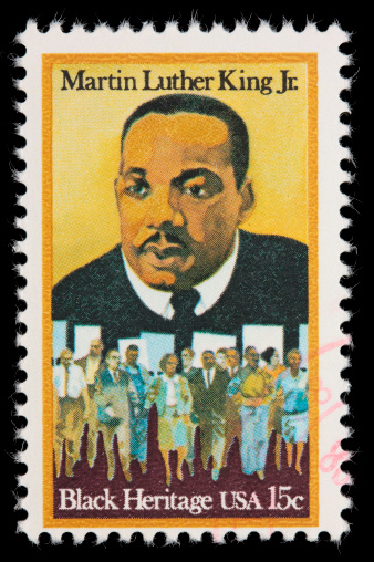Sacramento, California, USA - December 11, 2010: A 1979 USA postage stamp with a portrait of Martin Luther King Jr. above peace marchers carrying signs.