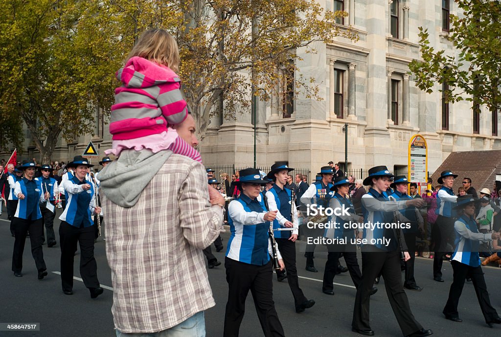 Watching a parade Adelaide, Australia - April 25th, 2012: A man with a child on his shoulders watches the annual ANZAC day parade ANZAC Day Stock Photo