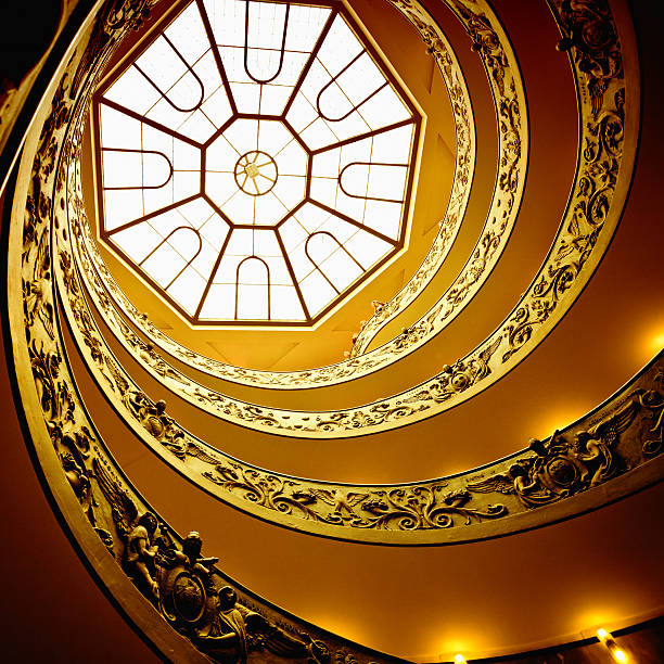 Rome, Italy - October 26, 2011: The famous spiral staircase that leads to the exit of the vatican museum inside the vatican city. Tourists are looking down.