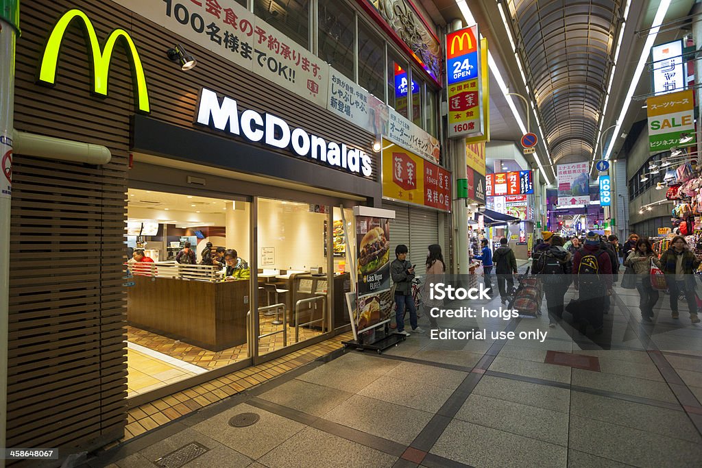 McDonalds Restaurant in a shopping arcade, Umeda, Osaka Osaka, Japan - February 6, 2012: McDonalds Restaurant in a shopping arcade in Umeda, Osaka. People can be seen walking through the arcade and sitting inside the restaurant. McDonald's Stock Photo