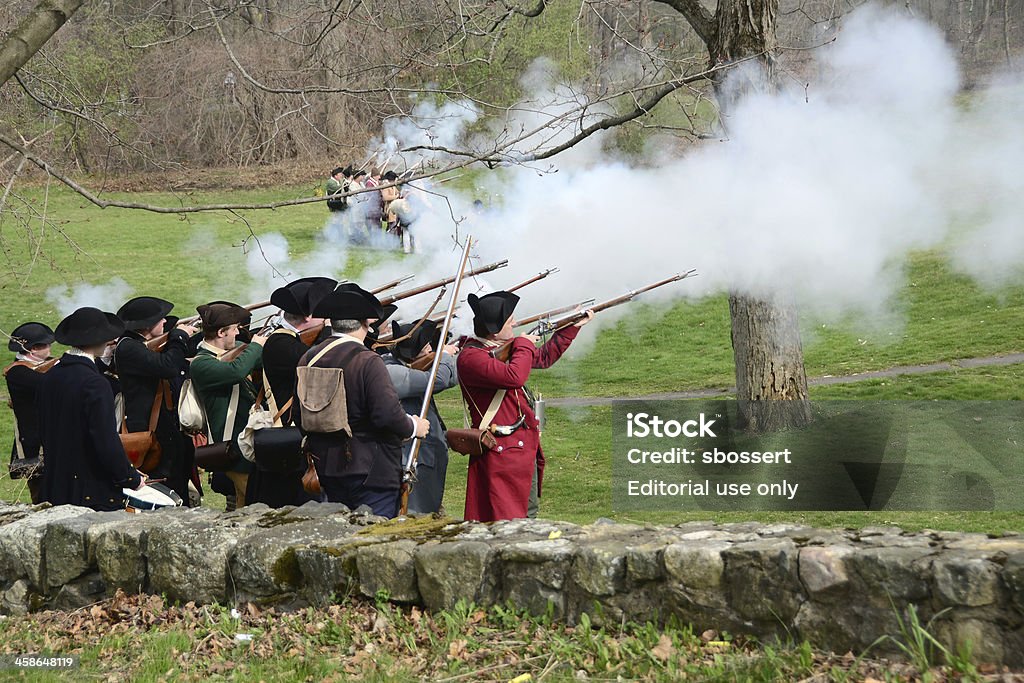 Patriot's Day Reenactment Lexington, Massachusetts, USA - April 14, 2012: Men dressed as American colonial militiamen or minutemen reenact one of the first battles of the American revolution as part of the annual Patriot's Day celebration. Colonial Style Stock Photo