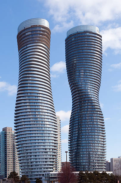 Mississauga, Ontario, Canada – February 20, 2012: The Absolute World condominium Towers in the city center of Mississauga Ontario on a sunny winter afternoon.  The hourglass shaped tower  has been nicknamed the Marilyn Monroe tower due to the curvy shape.