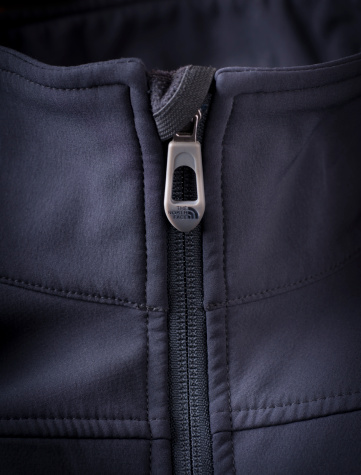 Pickering, Ontario, Canada - November 22, 2011: Closeup of The North Face zipper tab on the collar of a soft shell jacket.
