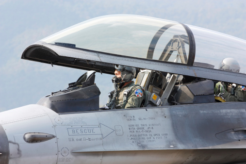 Chiang Mai , Thailand - January 10, 2009 : Fighter pilot in F-16 cockpit checking the aircraft system before taking off