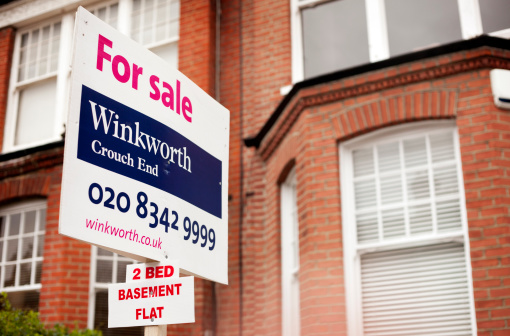 London, UK - March 1, 2011: A \\'For Sale\\' sign on a house in the fashionable North London suburb of Crouch End by local estate agents Winkworth.  Focus is on the sign with the building on offer blurred into the background.