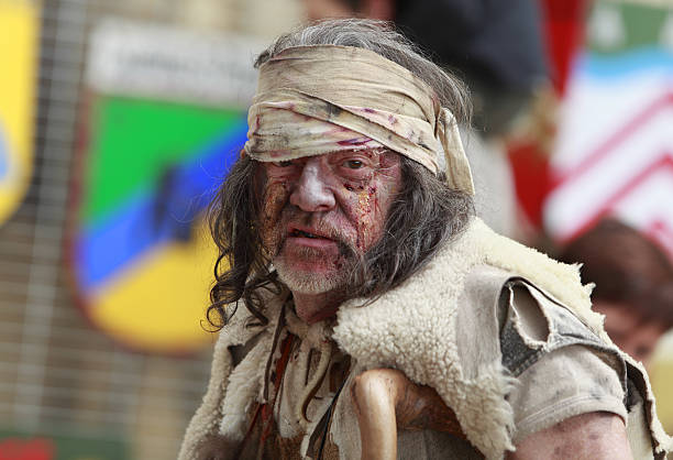 Portrait of a leprous man "Nogent de Rotrou, France,May,15th,2010:Portrait of a leprous man during, during the Week-end de L\\\'ascension-Grand Fete medievale in Nogent de Rotrou. This was a historical reenactment festival around the Saint Jean Castle." invalid person stock pictures, royalty-free photos & images