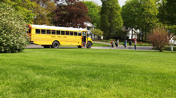 Penfield, New York, USA - May 13, 2011: A group of children meeting parents after getting off an afternoon school bus in Penfield, NY.