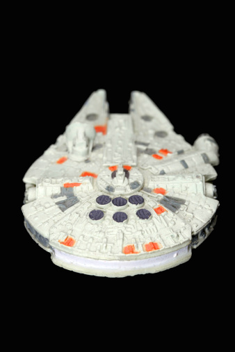 Vancouver, Canada - December 18, 2011: The Millenium Falcon from the Star Wars movie franchise on a black background. The model was made by Micro Machines, from Galoob.