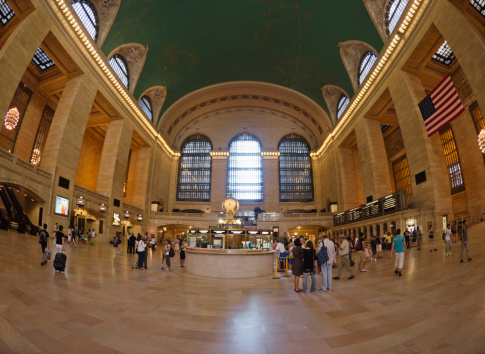 New York City, New york, USA - July 17, 2011: Interior view of the New York City central  Station full of tourist and commuters. Long exposure made in camera allow to catch the moviment of the people with his shadow. This is one of the most famous city landmark in new york form many many travelers . The image is taken with a fish-eye lens.