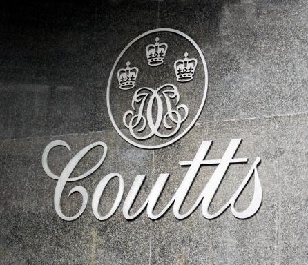 London, England - August 10, 2011: A sign on the marble tiled wall outside a branch of Coutts Bank, in Fleet Street, London. Coutts Bank was founded in the late 17th century and is an extremely exclusive private bank whose clients include HM The Queen.