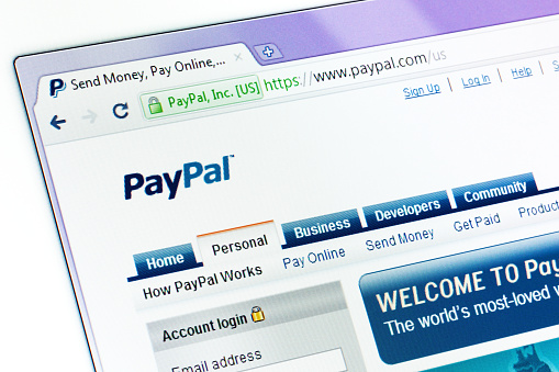 Kyiv, Ukraine - March 13, 2011: PayPal start page in browser window with internet address on top. PayPal is an e-commerce business allowing payments and money transfers to be made through the Internet. Online money transfers serve as electronic alternatives to traditional paper methods such as checks and money orders.