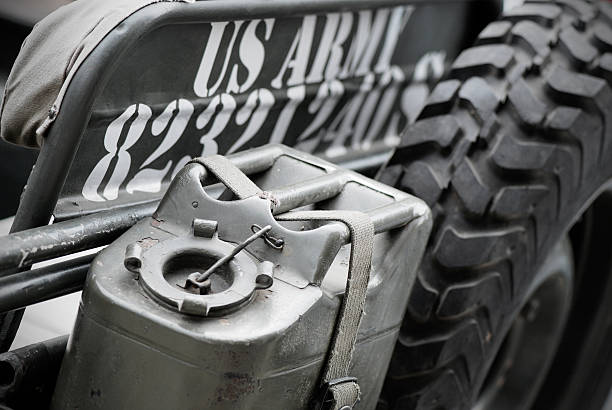 Close up on US Army Jeep MB38 A1 Borgosesia, Italy - September 11, 2011: Close up on US Army Jeep MB38 A1 parked in the street during town festival. Fuel tank and emergency tyre. fuel storage tank gasoline army military stock pictures, royalty-free photos & images