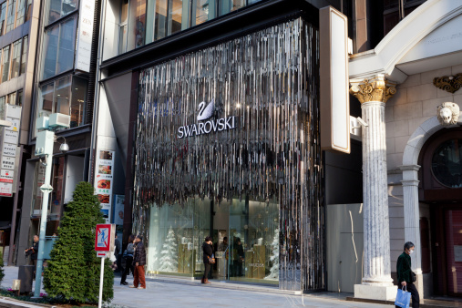 Tokyo, Japan - November 26, 2011: Pedestrians walk past a Swarovski Flagship Store in Tokyo, Japan. This store is located in 8-9-15 Ginza, Chuo-ku, Tokyo, Japan. Ginza shopping district is the most expensive real estate price in Japan.