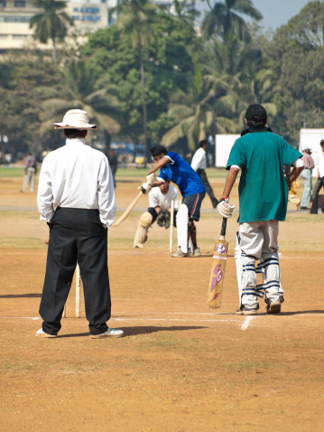 Mumbai, India - January 23, 2008: Recreational Cricket being played on a public park in Central Mumbai. Cricket is a popular past time in India, and can be seen played on the streets and in parks throughout the country.