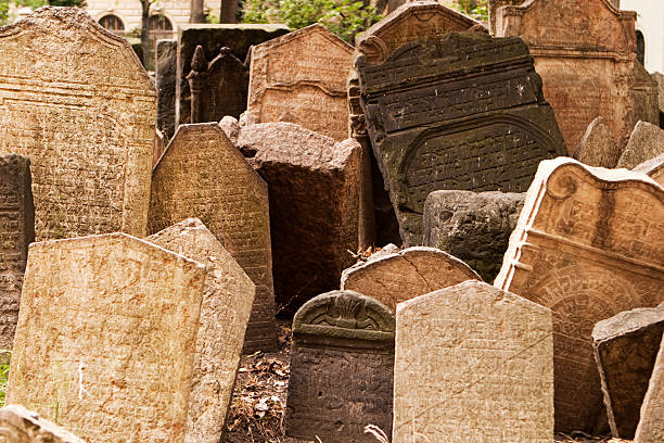 Headstones in Jewish Graveyard "Prague, Czech Republic - July 2, 2007: Old tombstones in the Josefov Cemetery are stacked close together and lean at crazy, uneven angles. The landmark Jewish cemetery is in the old ghetto of Prague and was in use from the early 15th century until 1787." crypts stock pictures, royalty-free photos & images