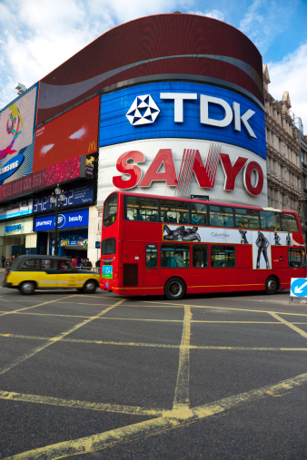 London, United Kingdom - September, 28th 2009: The most popular London landmark, Piccadilly Circus, with a red double decker bus and traditional black taxi cab. Piccadilly Circus is a  famous street junction with a video display and illuminated advertisements.