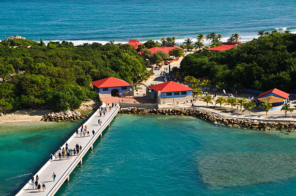 Dock at Labadee Labadee, Haiti-November 17, 2011: Criuise ship passengers from Royal Caribbean\'s \"Explorer of the Seas\" walk down a recently constructed dock for a day of sun and fun at the cruise company\'s private island. labadee stock pictures, royalty-free photos & images