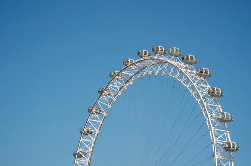 London, England - September 30, 2011: Abstract view of the London Eye against clear blue sky. The London Eye is the tallest Ferris wheel in Europe, and one of the most popular tourist attractions in the UK.