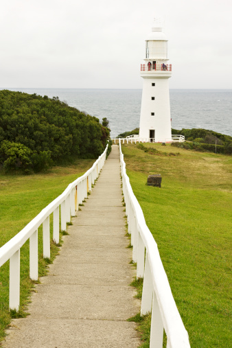 Cape Otway, Australia - April 13, 2011: Cape Otway Lighthouse with a person admiring the view from the top. Cape Otway in along the Great Ocean Road and it is the southern place of Australia.