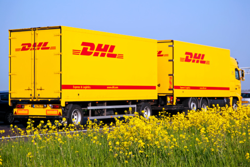 Utrecht, the Netherlands - April 20, 2009: DHL delivery truck drives on the A2 motorway between Utrecht and Amsterdam. DHL package express is part of the Deutsche Post and the world's largest logistics specialist.