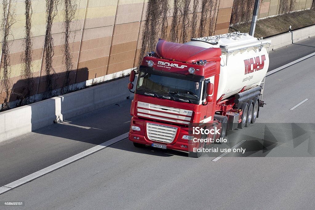 Silo truck on german Autobahn Wallau, Germany - February 3, 2012: A male driver in a large silo truck of german freight transportation Michels on german autobahn A66 near Wiesbadener Kreuz. The pictured tractor is a DAF XF truck. DAF Trucks NV is a Dutch truck manufacturer. Minor motion blur Adult Stock Photo