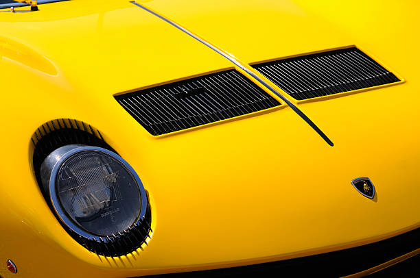 Lamborghini Miura S Spa, Belgium - June 29, 2008: Detail on the hood of a classic yellow Lamborghini Miura S sports car. The car is on display during the 2008 Spa Italia event. lamborghini miura stock pictures, royalty-free photos & images