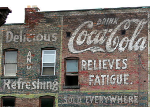 Schenectady, NY, USA - May 22, 2006.  Faded painted vintage Coca Cola advertisement from the 1940\'s.