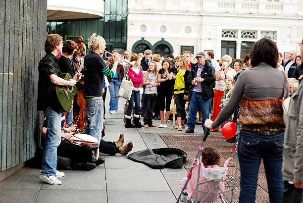 Liverpool, England - September 7, 2008: A group of young musicians performing in the streets of Liverpool, playing various musical instruments and collecting money in a guitar case.